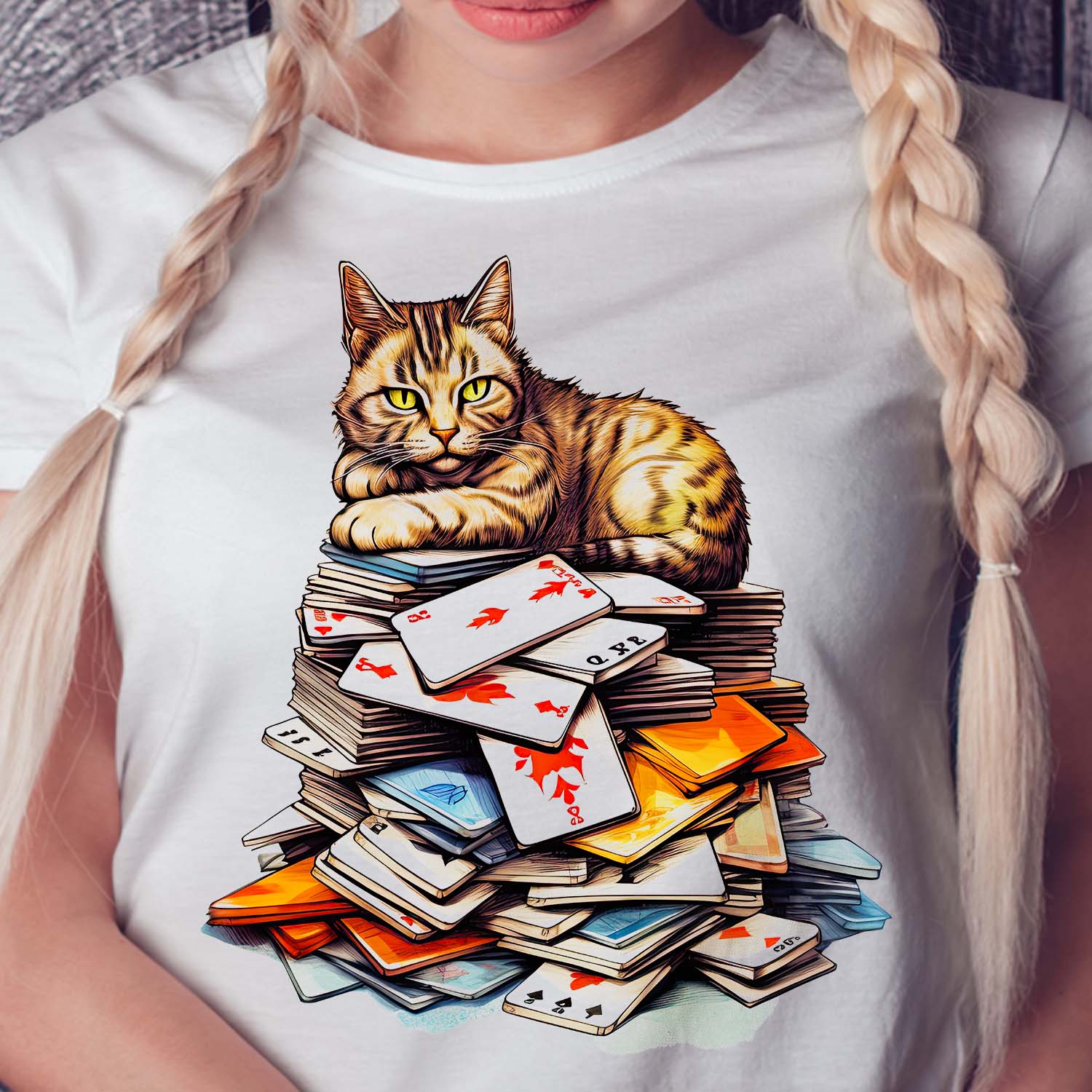 cat sitting on a pile of playing cards